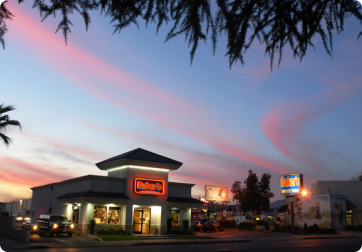 A bakers drive thru store at night in 2024